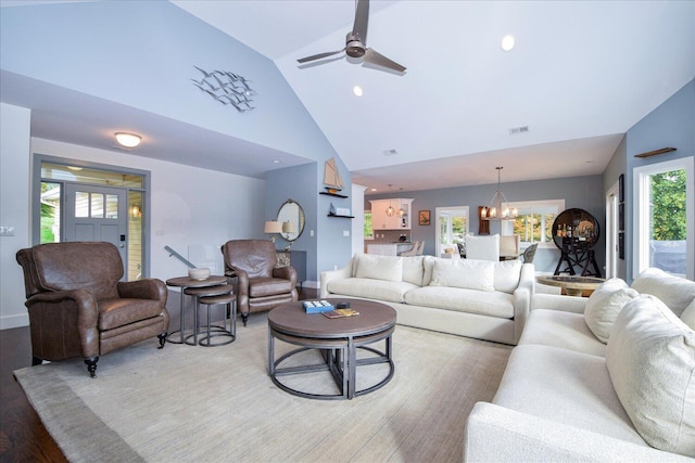 living room with high vaulted ceiling, recessed lighting, wood finished floors, visible vents, and baseboards