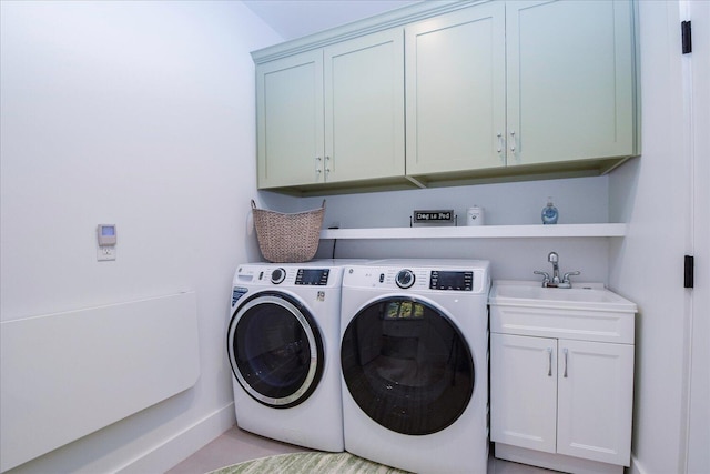 clothes washing area featuring separate washer and dryer, a sink, and cabinet space