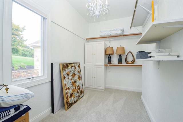 interior space featuring a chandelier and light colored carpet