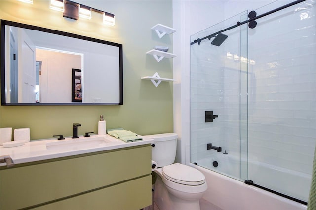 full bathroom with enclosed tub / shower combo, vanity, and toilet