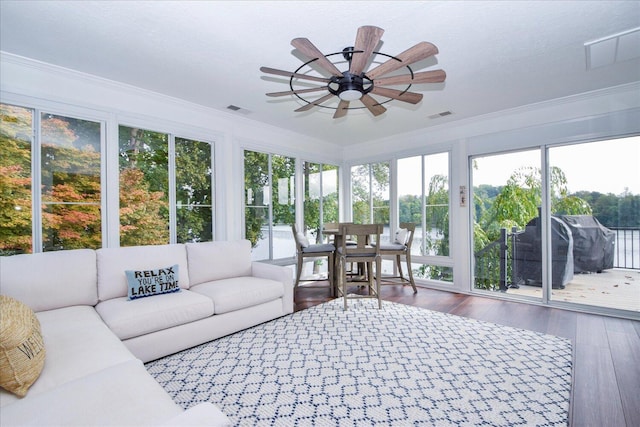 sunroom / solarium featuring visible vents and ceiling fan