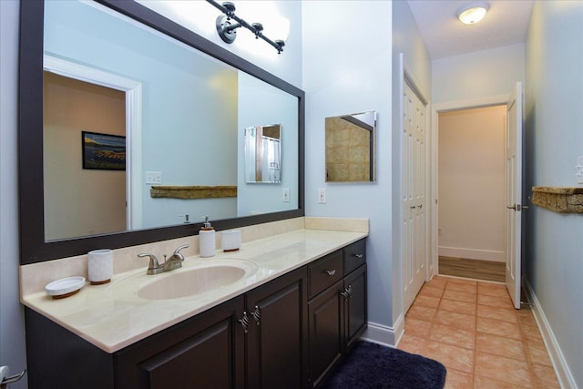 bathroom with tile patterned flooring, vanity, and baseboards