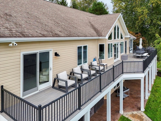 wooden deck featuring a patio and outdoor dining space