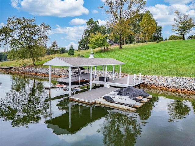 dock area featuring a water view, a yard, and boat lift