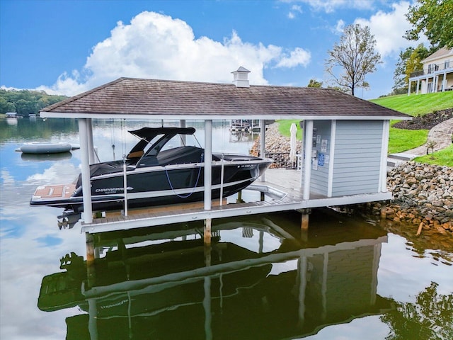 view of dock with a water view and boat lift