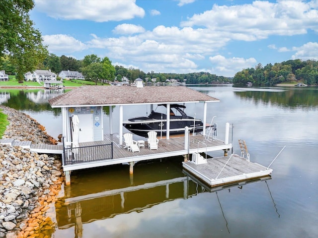 dock area with a water view and boat lift