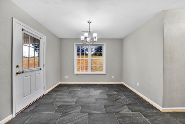 unfurnished dining area with visible vents, baseboards, and an inviting chandelier