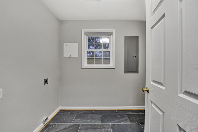 laundry room with laundry area, hookup for an electric dryer, electric panel, and baseboards