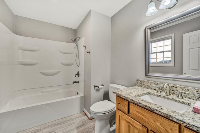 bathroom with shower / washtub combination, vanity, and toilet