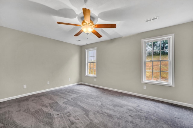 spare room featuring baseboards, visible vents, and carpet flooring