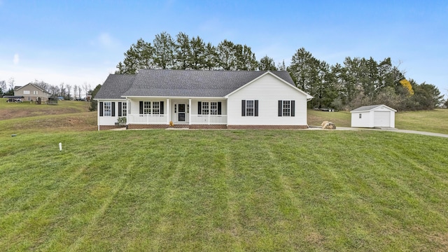 ranch-style house with a porch, a front yard, a detached garage, and an outbuilding