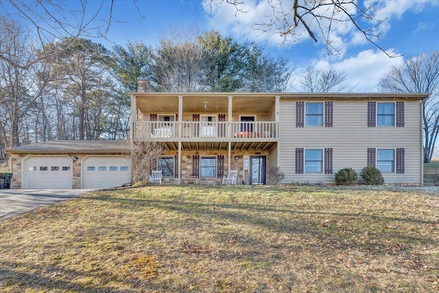 view of front of house with aphalt driveway, an attached garage, stone siding, a chimney, and a front yard