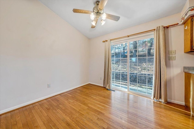 spare room with baseboards, ceiling fan, visible vents, and light wood finished floors