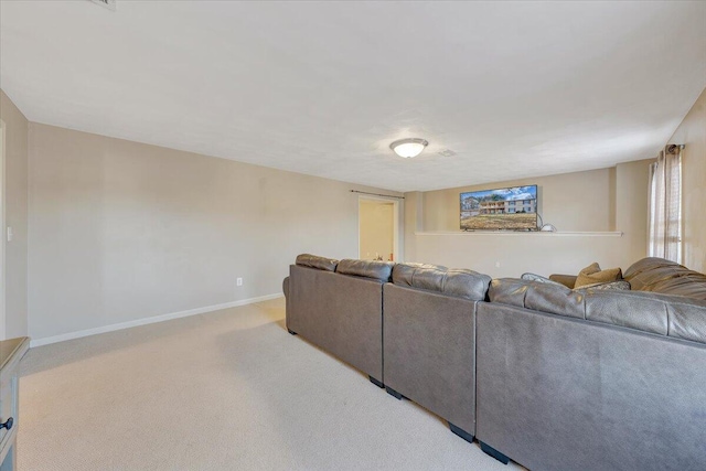 carpeted living room featuring baseboards