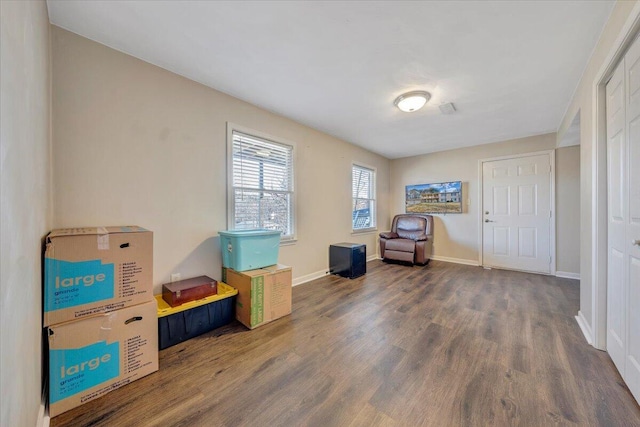 interior space with baseboards and wood finished floors