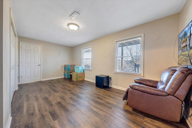 sitting room with baseboards and wood finished floors