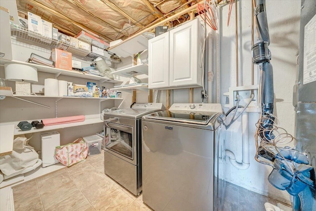 laundry area featuring independent washer and dryer and cabinet space