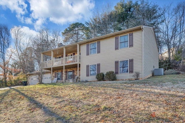 view of front of house featuring central AC, a front lawn, a chimney, and a balcony