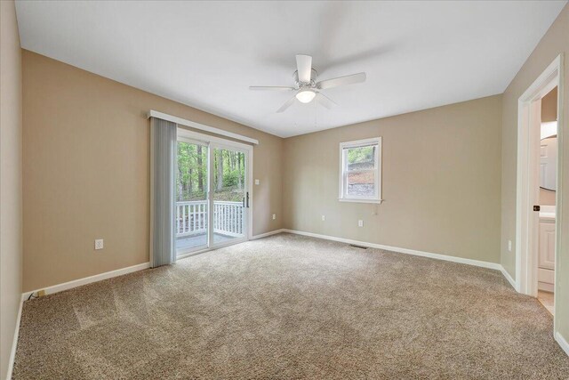 unfurnished room with carpet flooring, baseboards, and a ceiling fan