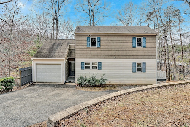 view of front of home with a garage and aphalt driveway