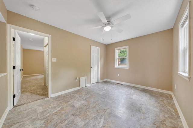 unfurnished bedroom with baseboards, ceiling fan, and visible vents