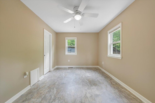 empty room with baseboards and a ceiling fan
