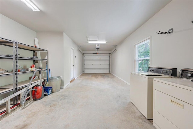 garage featuring baseboards and washer and dryer