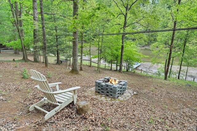 view of yard featuring an outdoor fire pit