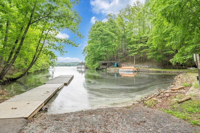 exterior space featuring a dock and a water view