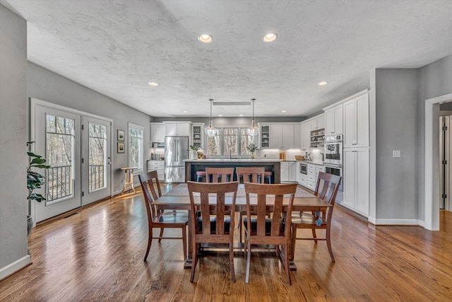 dining area with dark wood-style flooring, recessed lighting, and baseboards