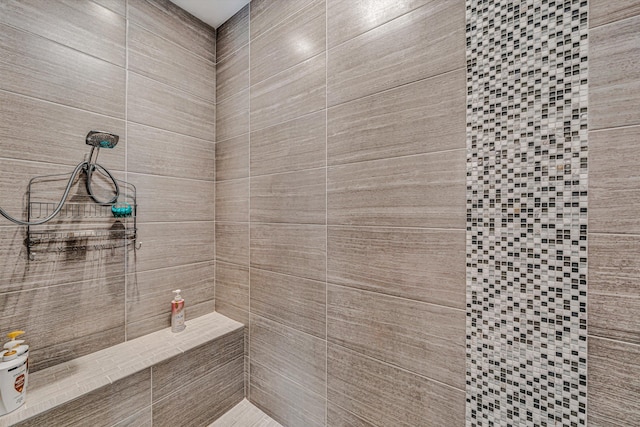 bathroom with tiled shower