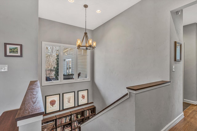 stairs with a notable chandelier and baseboards