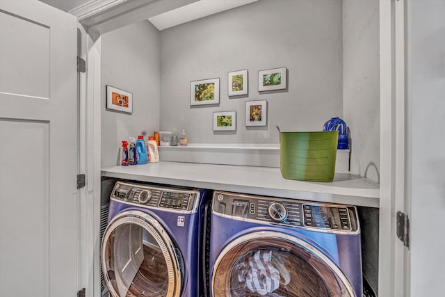 clothes washing area featuring laundry area and washing machine and dryer