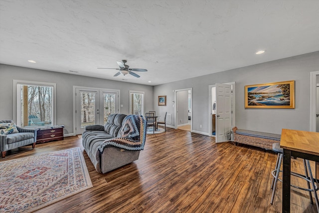 living area with french doors, recessed lighting, wood finished floors, and baseboards