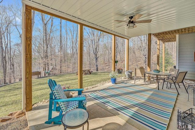 view of patio with outdoor dining space and a ceiling fan