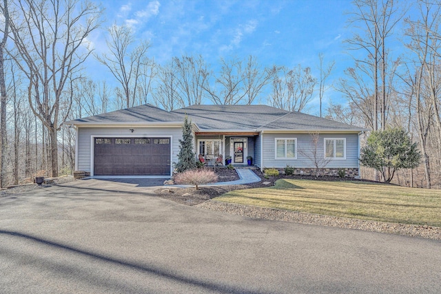 ranch-style house with a garage, driveway, and a front yard