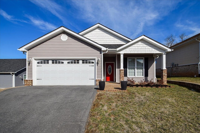 craftsman-style home with a garage, a front yard, and driveway