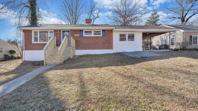 single story home featuring brick siding, a chimney, and a front lawn