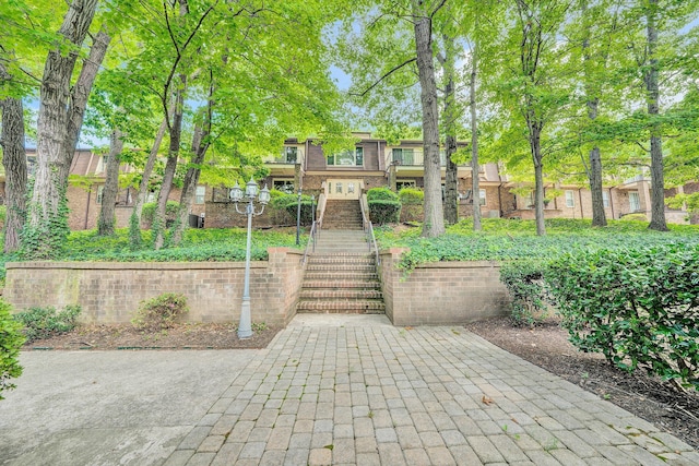 exterior space featuring brick siding and stairway