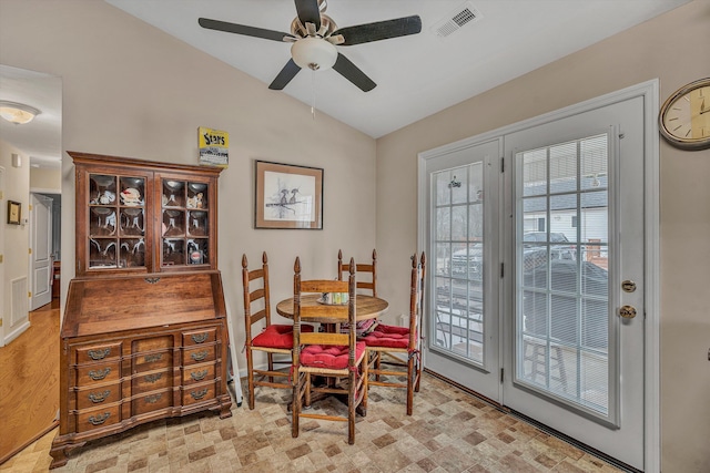 dining room with lofted ceiling, ceiling fan, a wealth of natural light, and visible vents