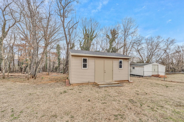 view of shed featuring fence