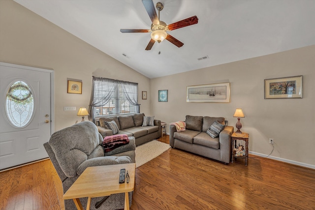 living room with lofted ceiling, wood-type flooring, visible vents, ceiling fan, and baseboards