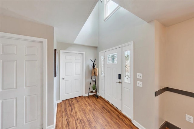 foyer with wood finished floors and baseboards