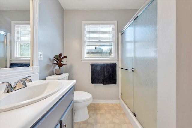 full bath featuring baseboards, toilet, a shower stall, and vanity