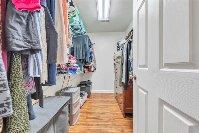 spacious closet featuring light wood-style flooring