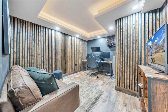 office area with a tray ceiling, wood finished floors, and recessed lighting