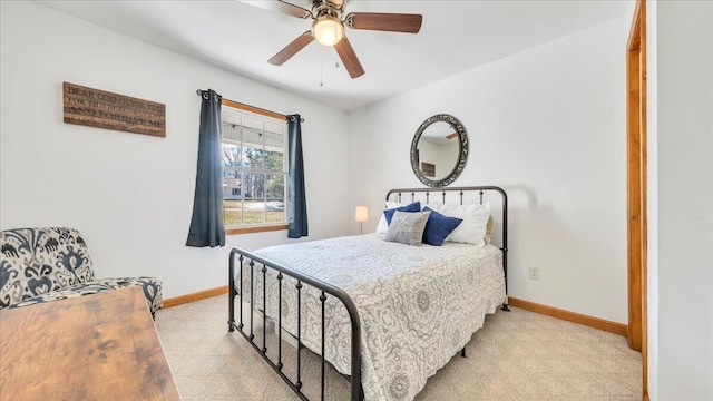 carpeted bedroom with baseboards and a ceiling fan