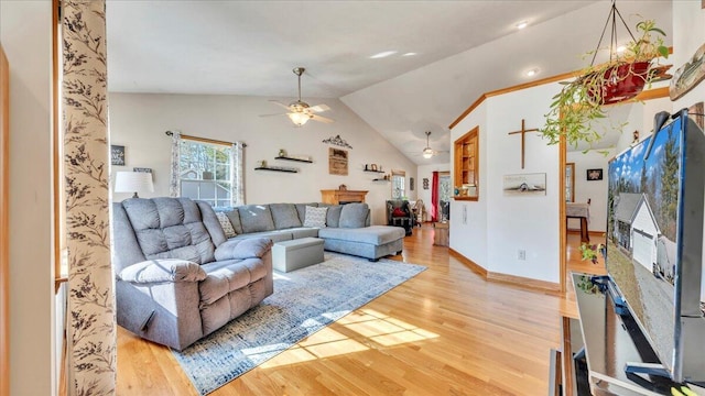 living room with a ceiling fan, vaulted ceiling, baseboards, and wood finished floors