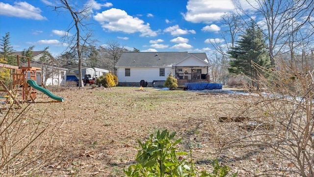 back of house featuring a playground