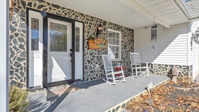 doorway to property featuring covered porch